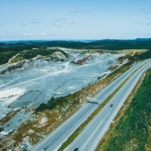 pexels photo 9213609 9213609 A breathtaking aerial shot of a highway and a quarry blending into the lush countryside landscape.